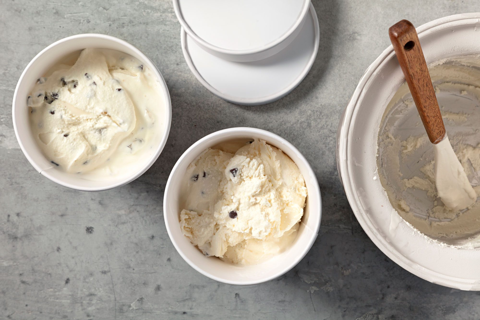 overhead shot; grey background; Transferred ice cream to freezer containers;