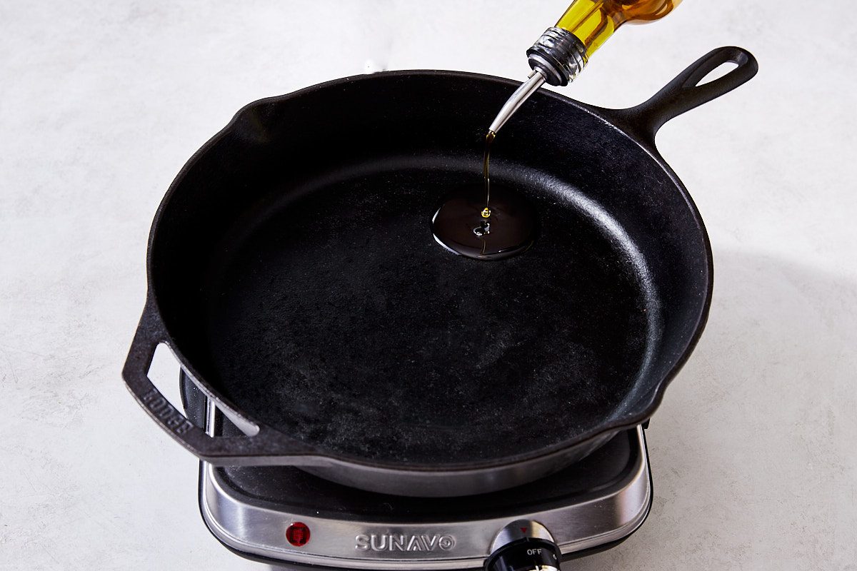 Filet Mignon Step 2- pouring oil into hot cast iron skillet