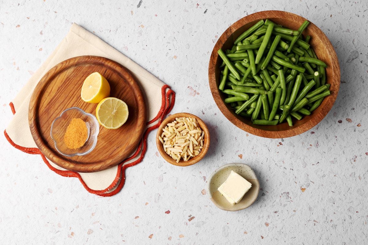 Ingredients laid out in various bowls for Taste of Home's Green Bean Almondine.