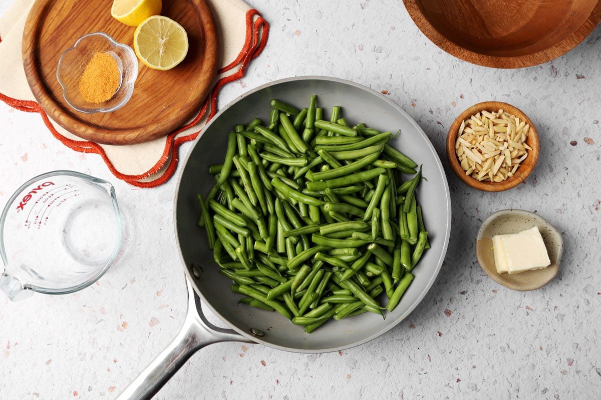 Taste of Home's Green Bean Almondine close up in a skillet being cooked.