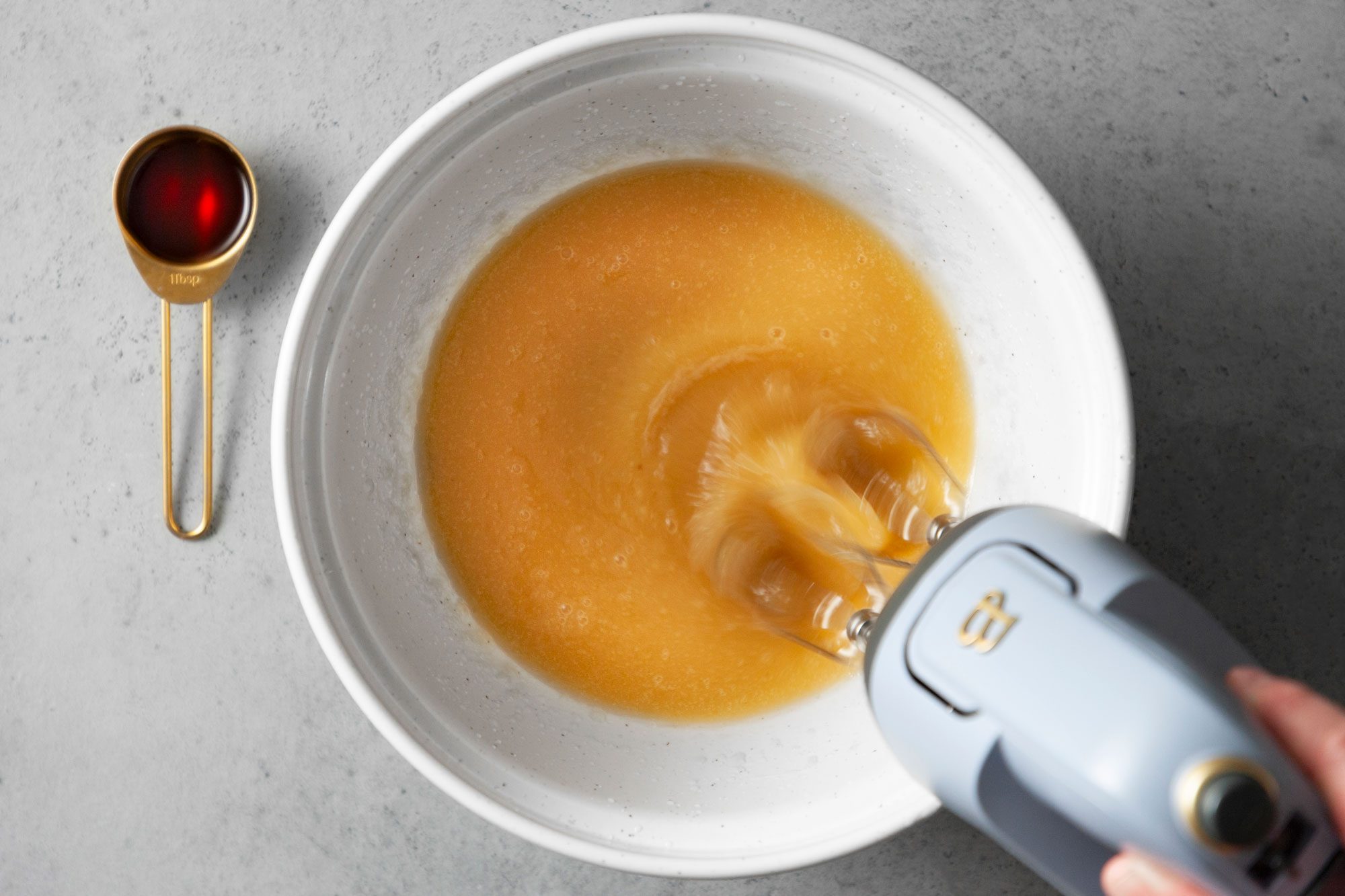 In a large bowl, beat honey, applesauce and oil until light and fluffy; grey background;