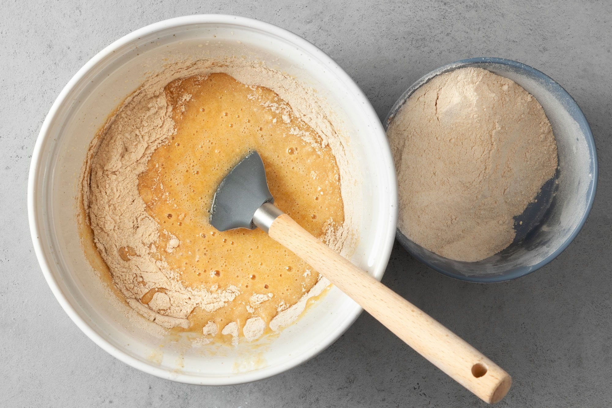 In another bowl, whisk flour, cinnamon, baking powder, salt and baking soda; grey background;