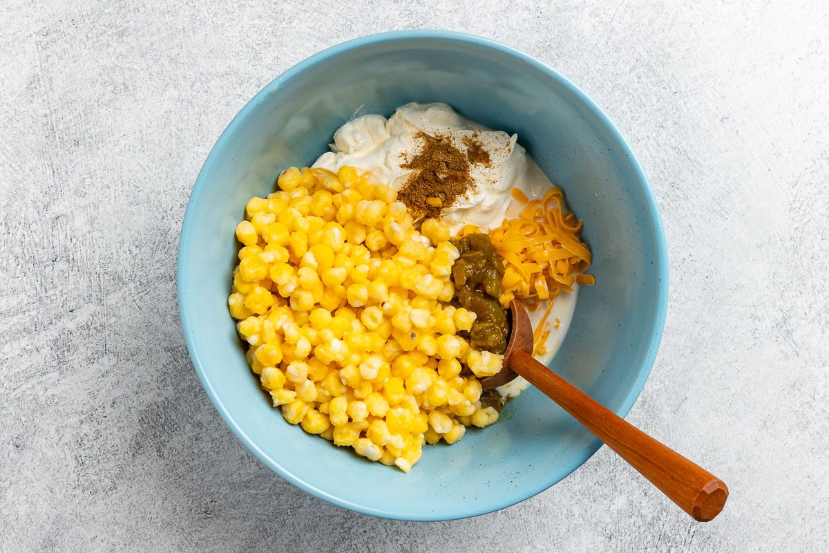 Taste of Home Hominy Casserole recipe photo of the ingredients added to a mixing bowl.