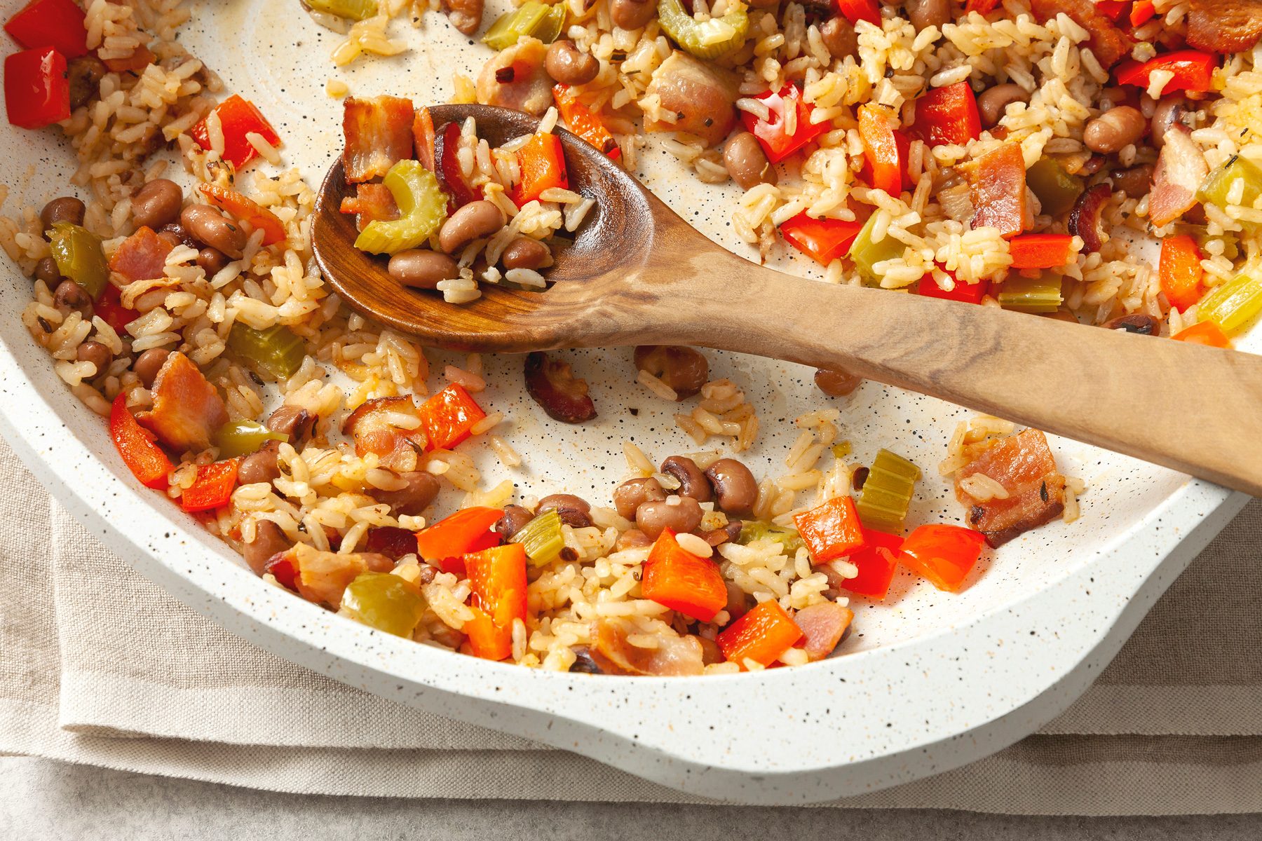 Hoppin John in serving bowl with wooden spoon