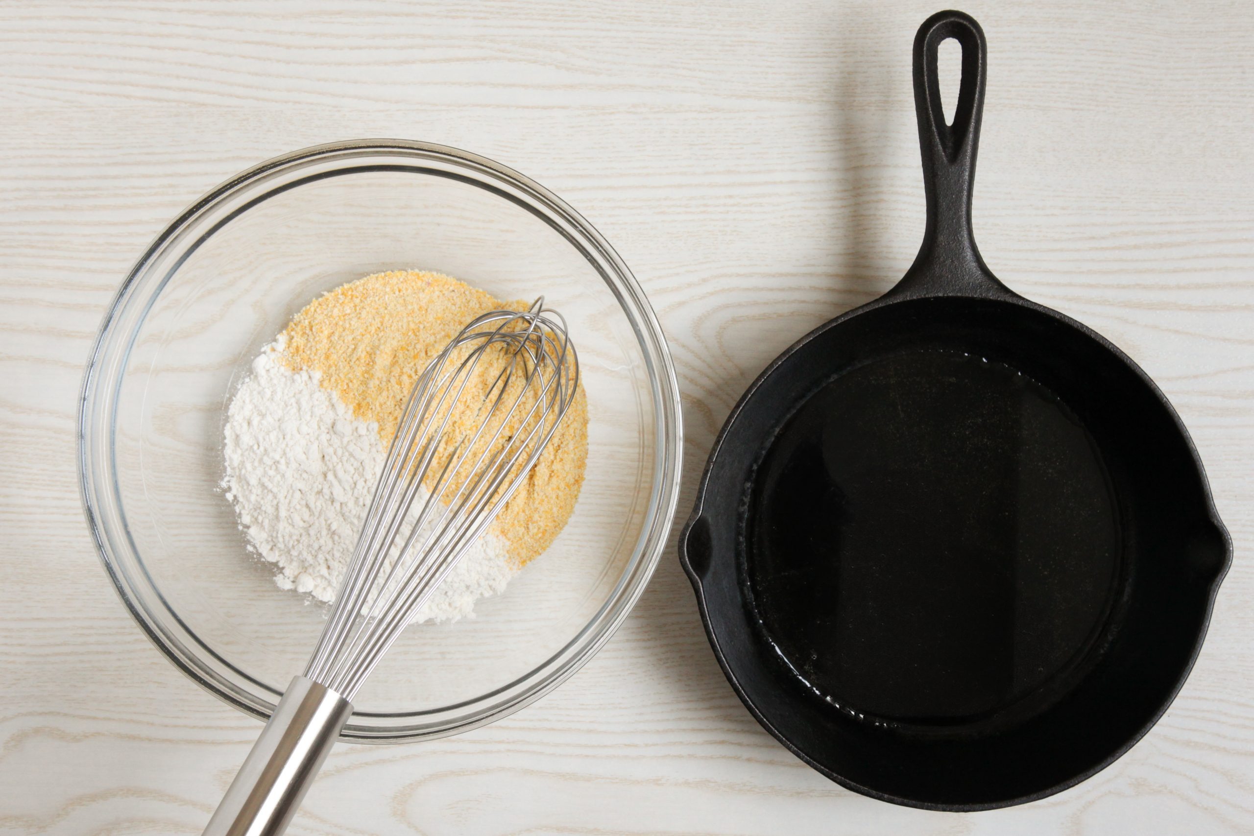 Dry ingredients and prepped cast iron skillet for cornbread