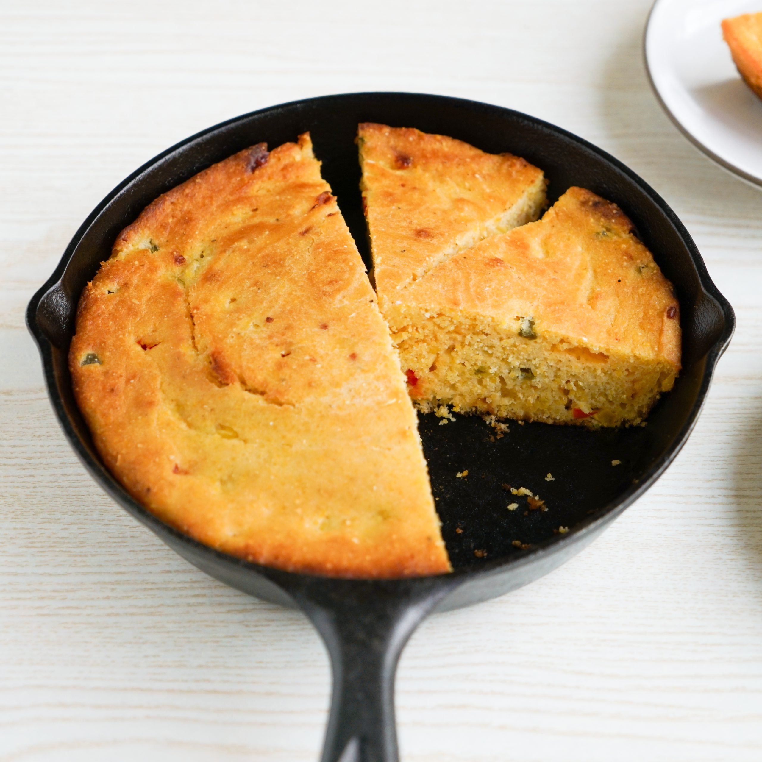 Sliced jalapeño cornbread in a skillet