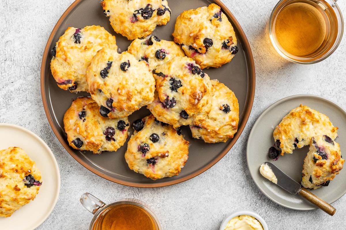 Taste of Home Lemon Blueberry Scones recipe photo of the finished scones on a serving platter and plates.