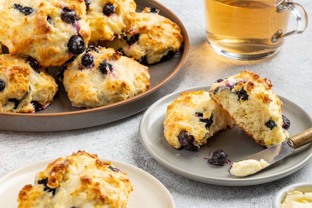 Taste of Home Lemon Blueberry Scones recipe photo of the finished scones on a serving platter and plates.