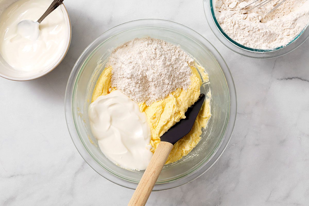 Creamed butter with flour and sour cream mixture in a bowl for Step 2 of Lemon Cake recipe for Taste of Home