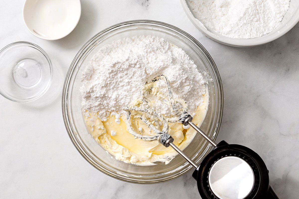 Lemon Frosting Ingredients In A Bowl For Step 5 Of Lemon Cake For Taste Of Home