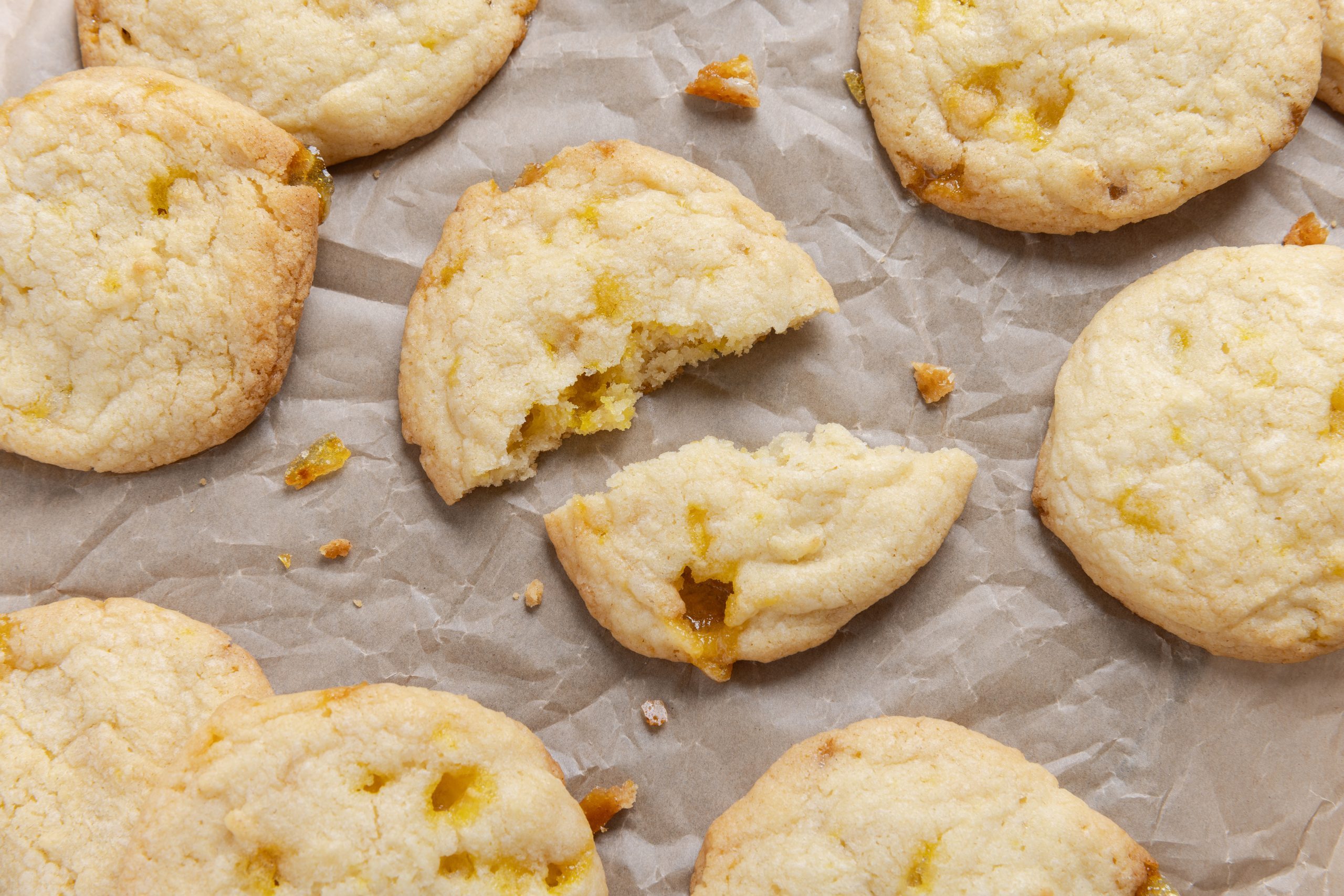 Cookies spread on parchment paper.