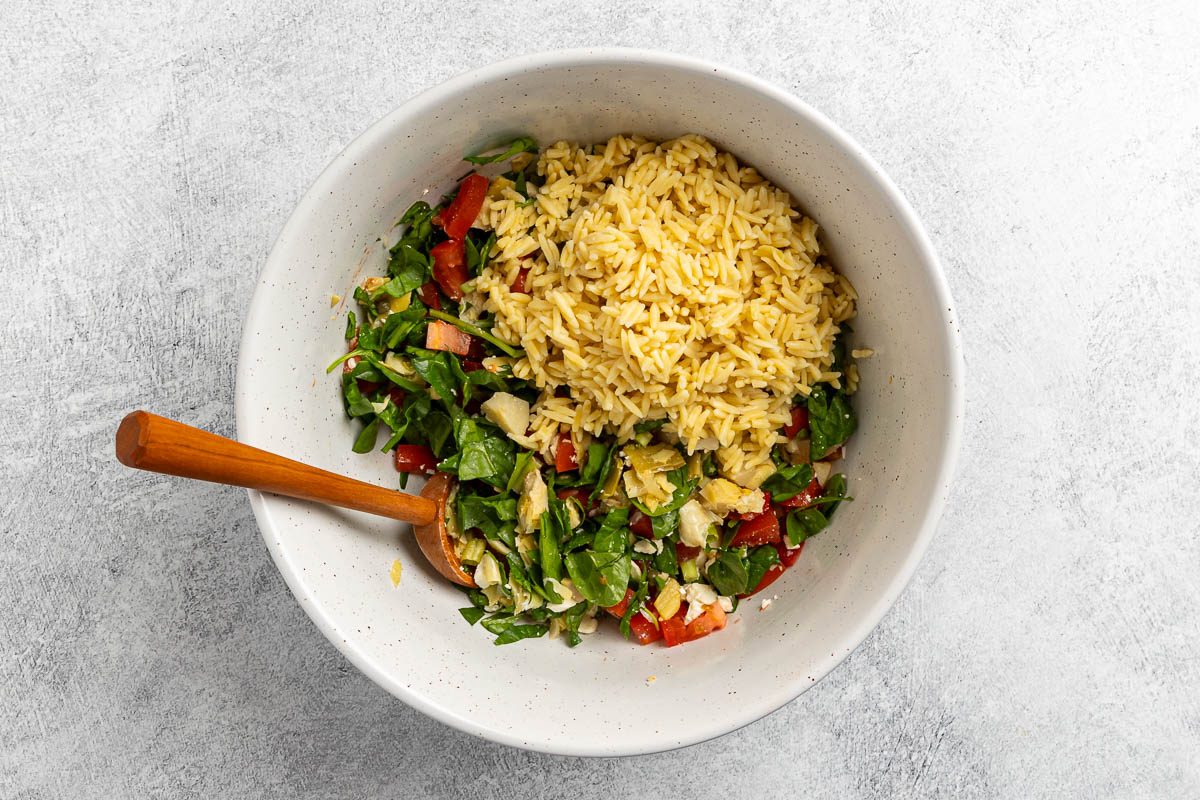 Taste of Home Lemon Orzo Salad recipe photo of the cooked orzo added to the mixing bowl.