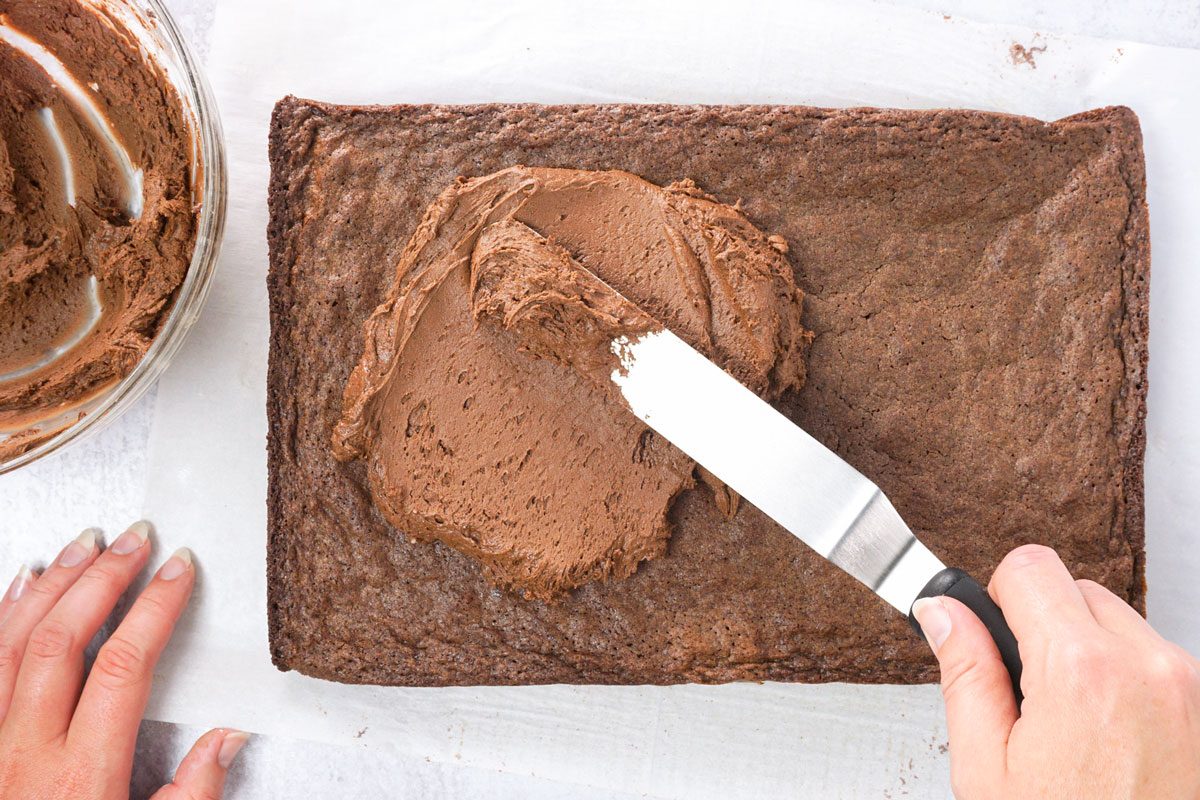 adding frosting to brownies