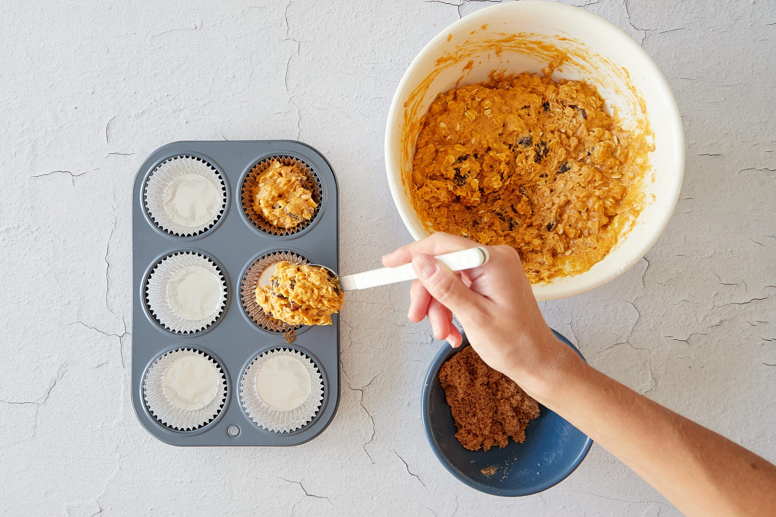 Prepare the pumpkin oatmeal muffins for baking.