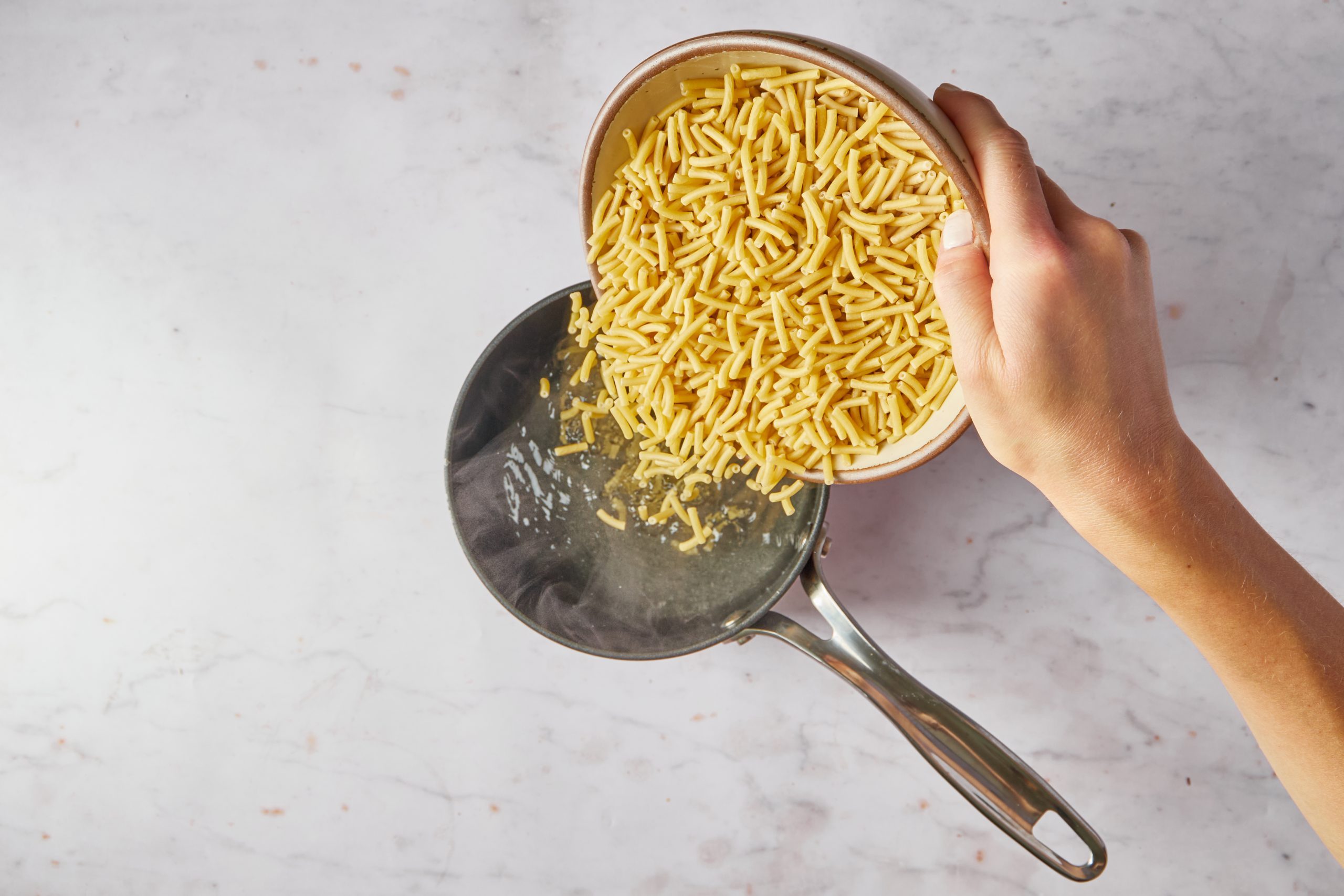 Cook the pasta for the Mexican mac and cheese.