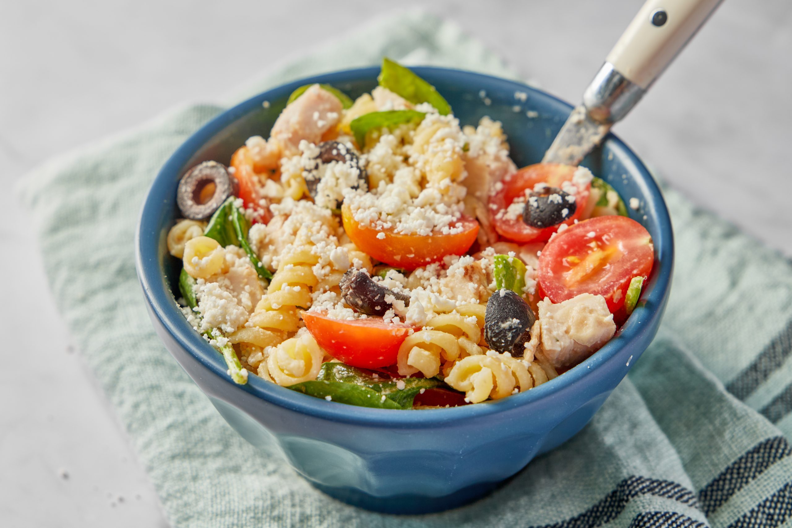 Chicken pasta salad can be a light, healthy lunch in its own right, not just a side dish. This one is especially healthy, thanks to its use of whole wheat pasta and especially its hummus-based dressing.