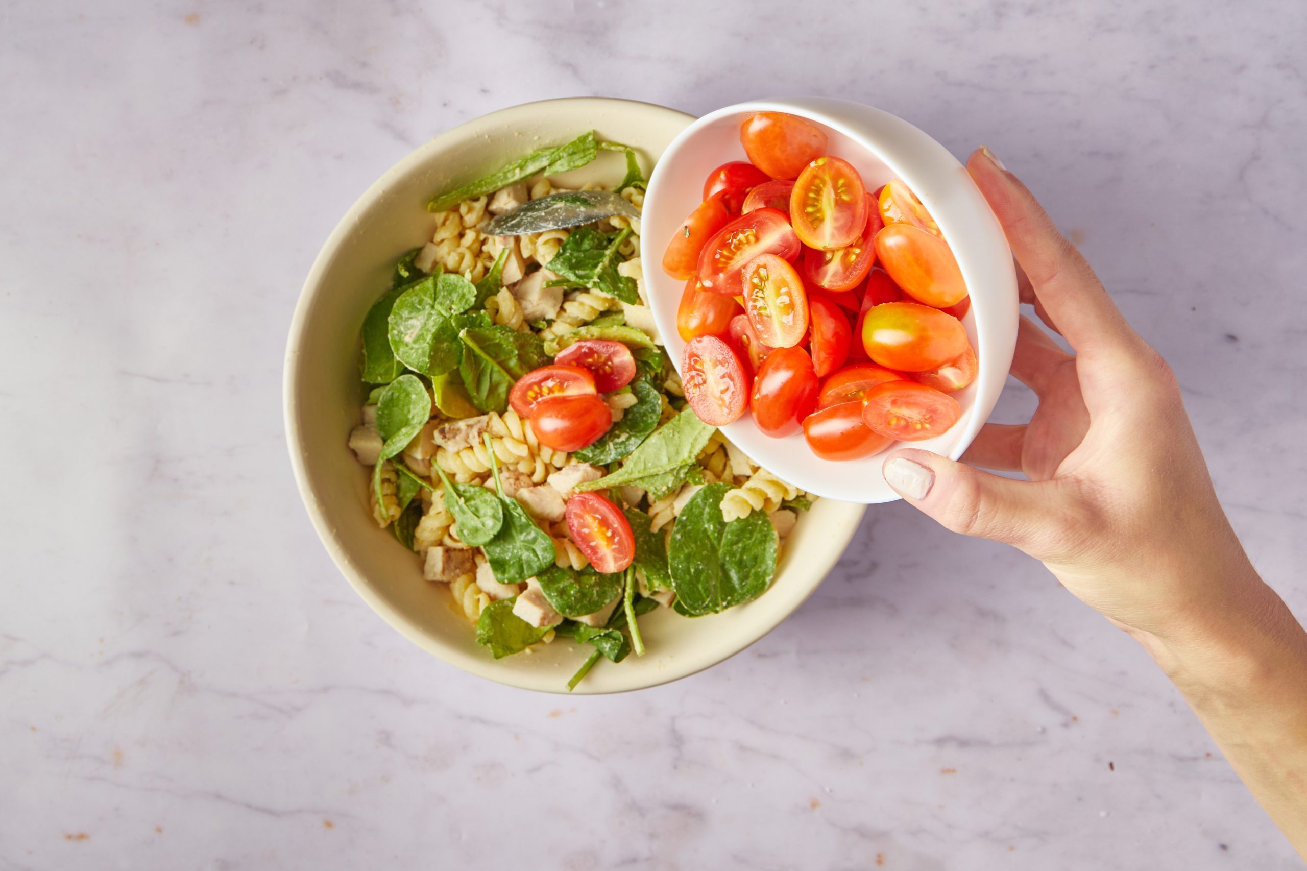 Combine the ingredients for chicken pasta salad.