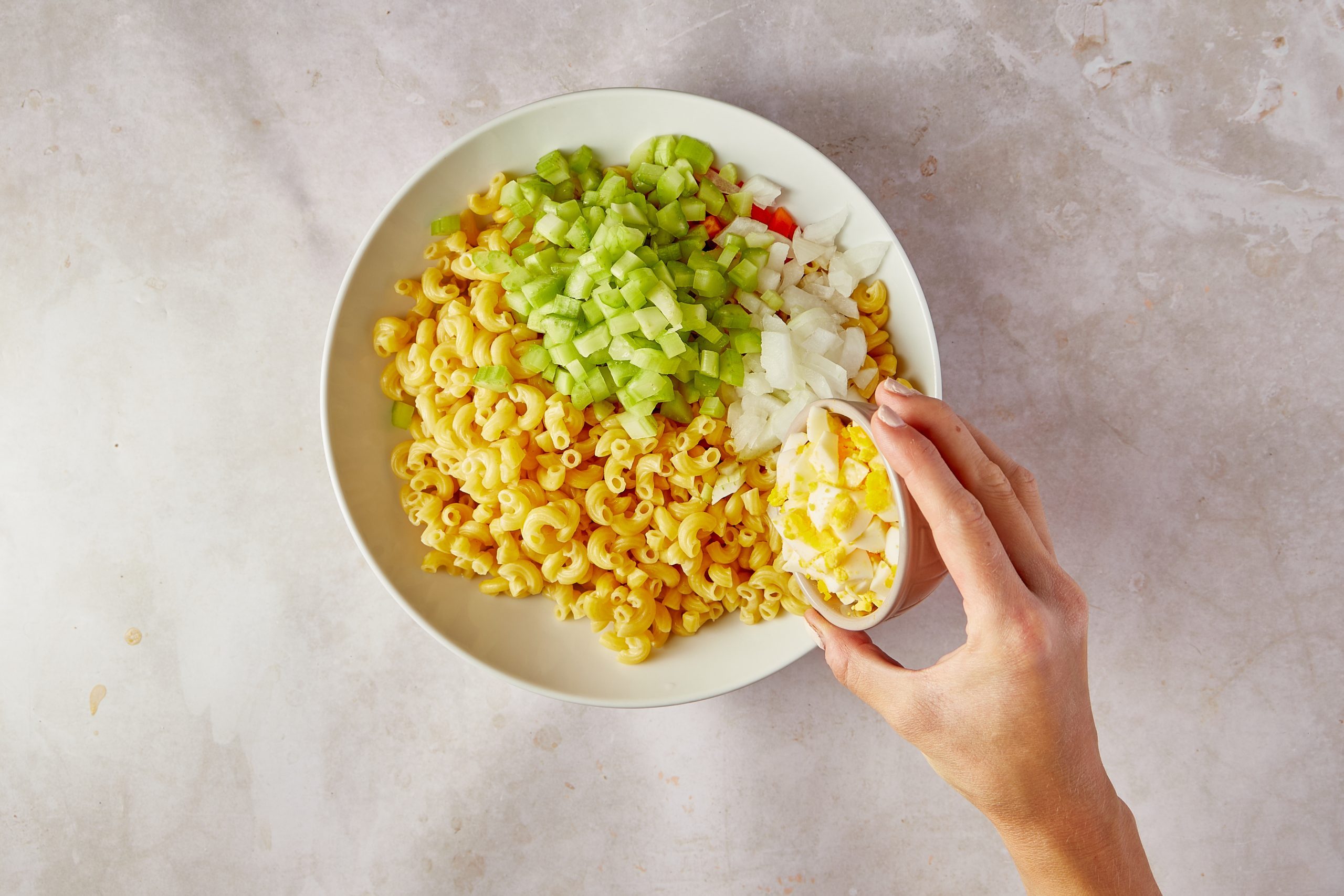 Combine the ingredients for Amish macaroni salad.