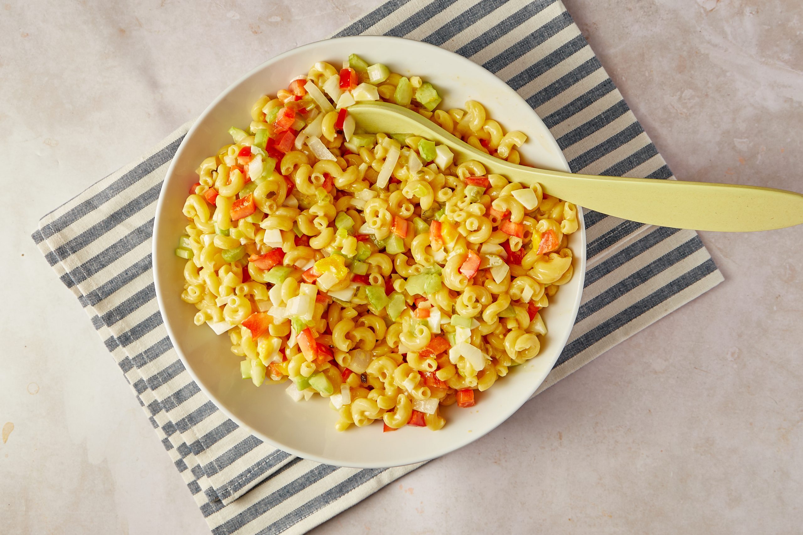 Amish macaroni salad is a perfect side dish for summer get-togethers. Make up a big bowl for your next barbecue or block party, and wait for the compliments to roll in.