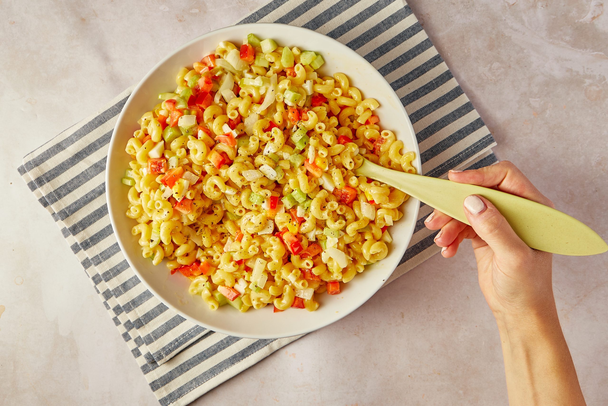 Amish macaroni salad is a perfect side dish for summer get-togethers. Make up a big bowl for your next barbecue or block party, and wait for the compliments to roll in.