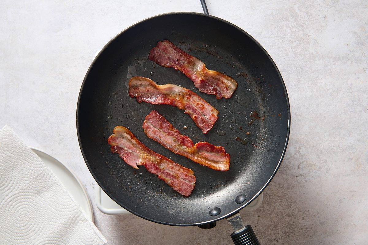 Cooking the bacon in a large skillet