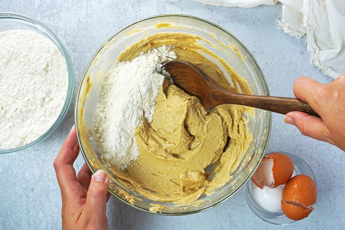 Mixing peanut butter cookies dough with a wooden spoon for Taste of Home RMS 7873