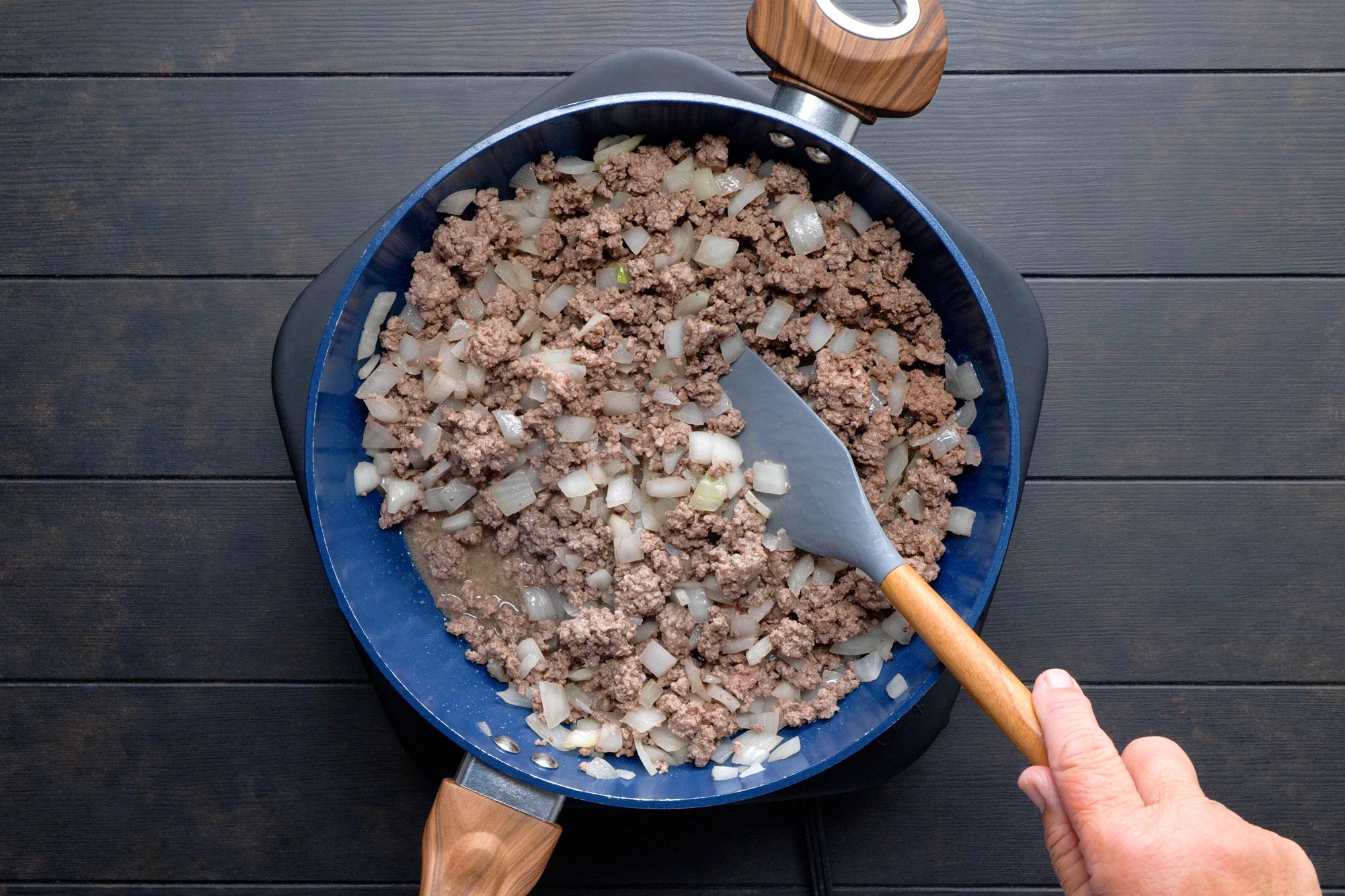 In a large skillet, cooking beef and onion