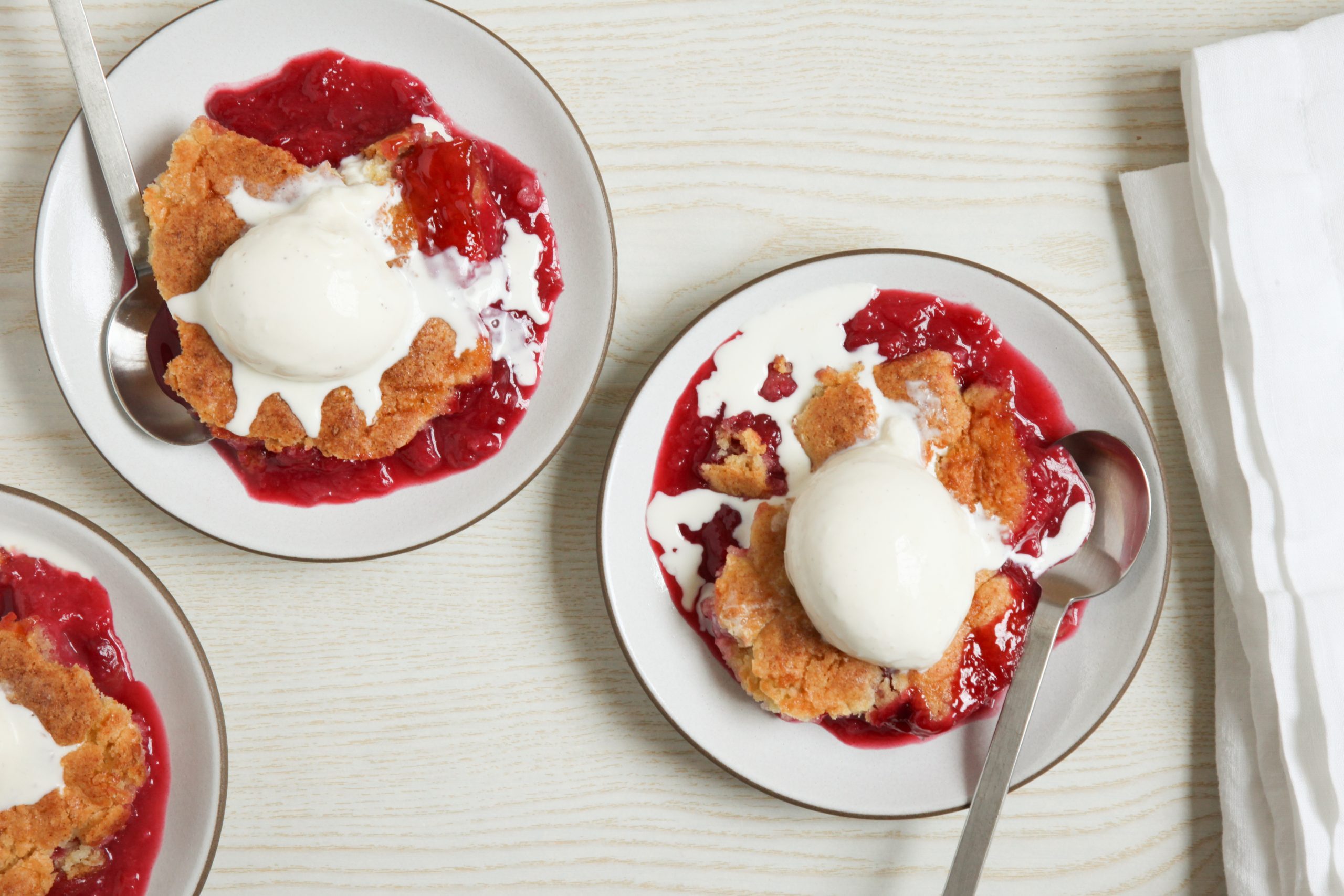 Plum cobbler topped with vanilla ice cream