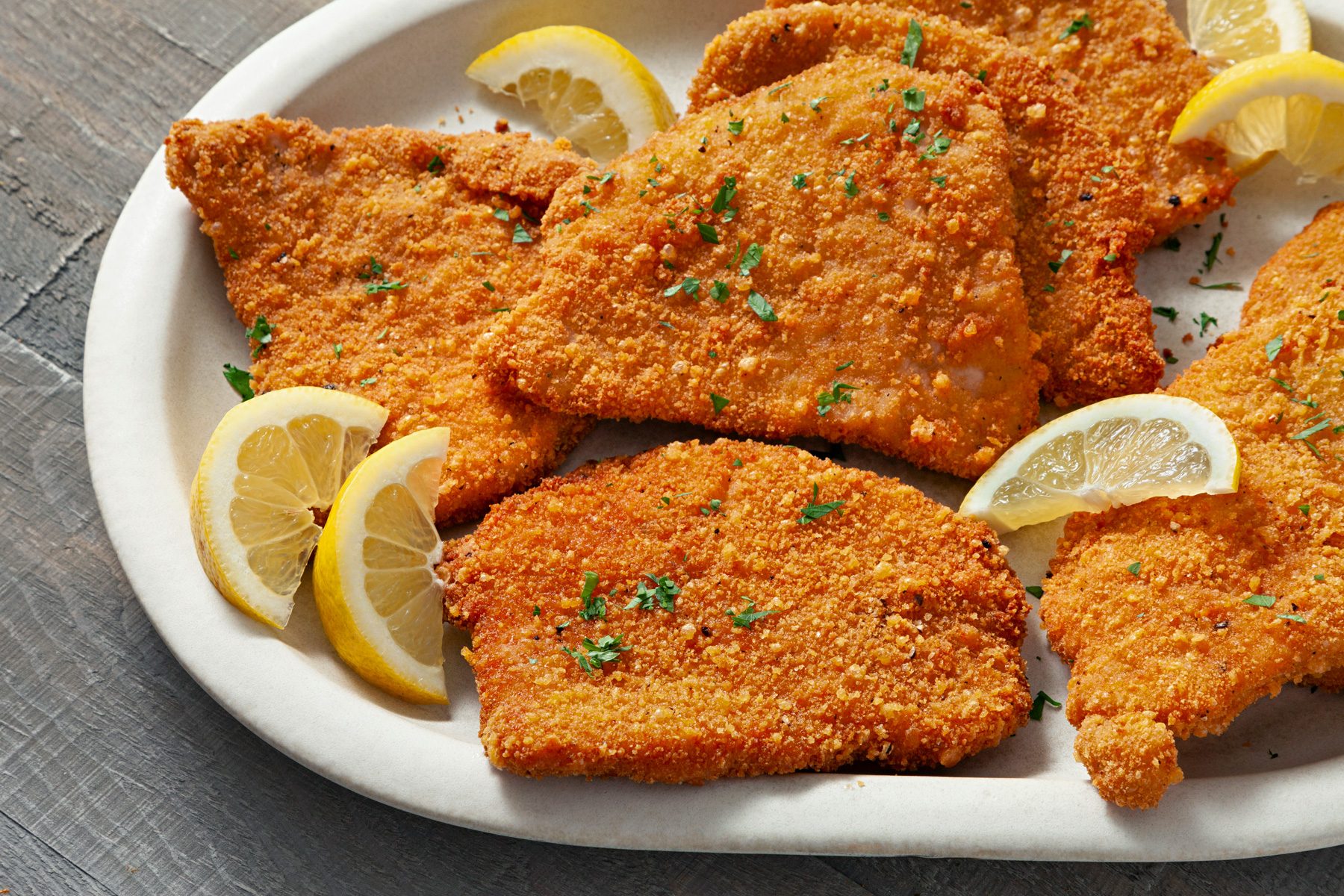 Pork Milanese served with Lemon on a plate 