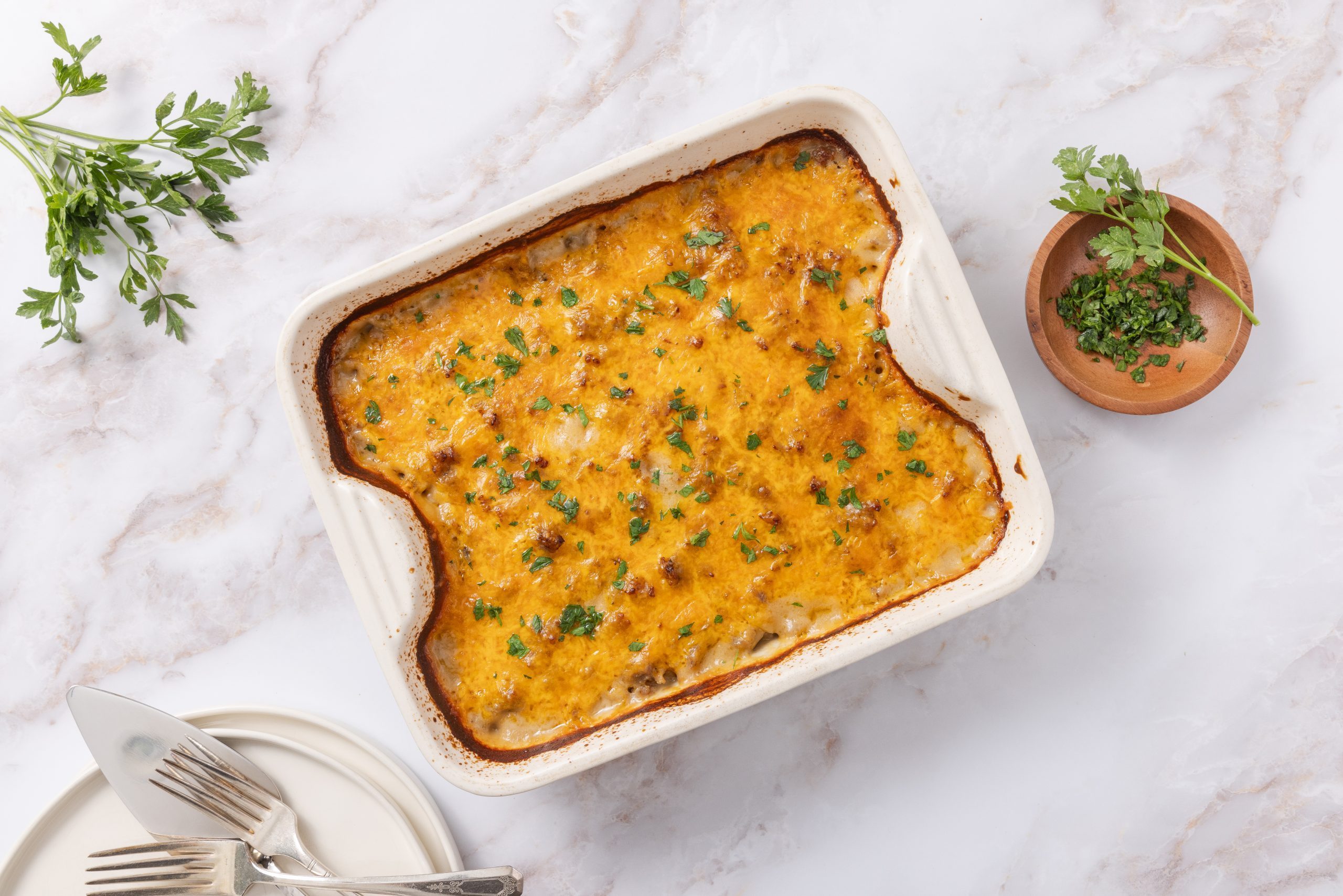 Casserole baked in ceramic baking dish garnished with fresh parsley.