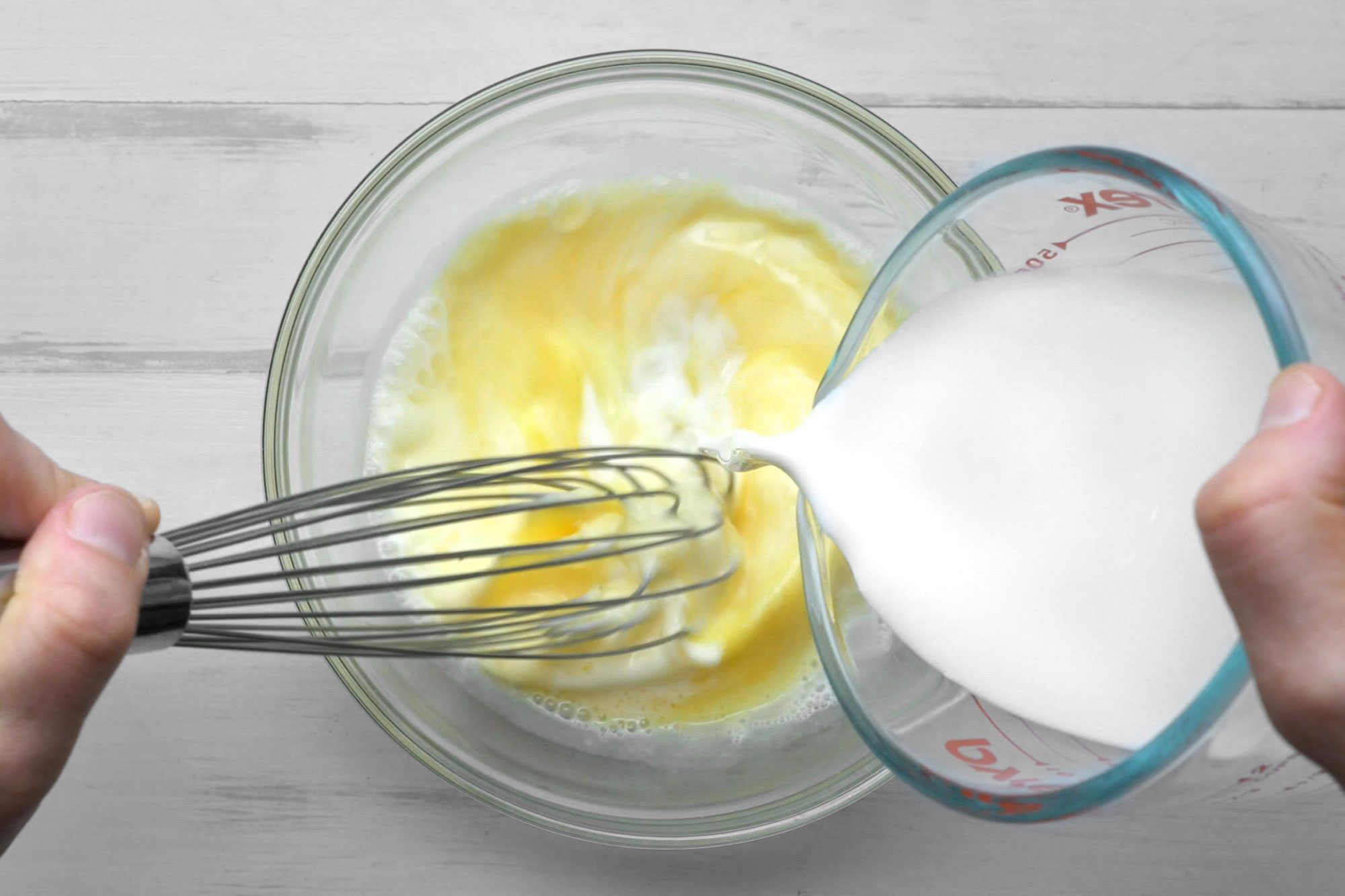 overhead shot; white background; In a small bowl, whisk the eggs, milk, sugar with whisker;