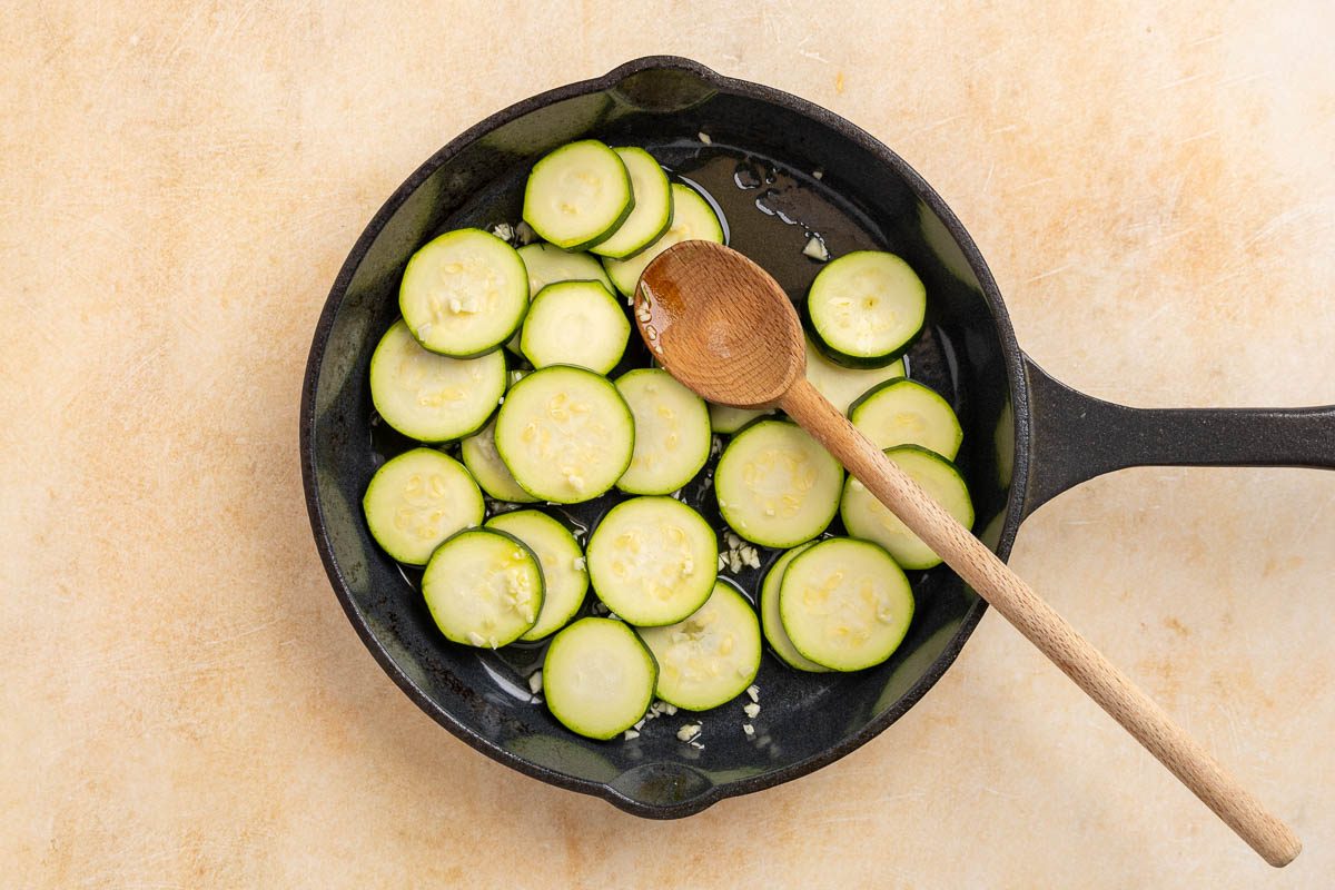 Taste of Home sauteed zucchini recipe photo of zucchini raw in a pan with oil.