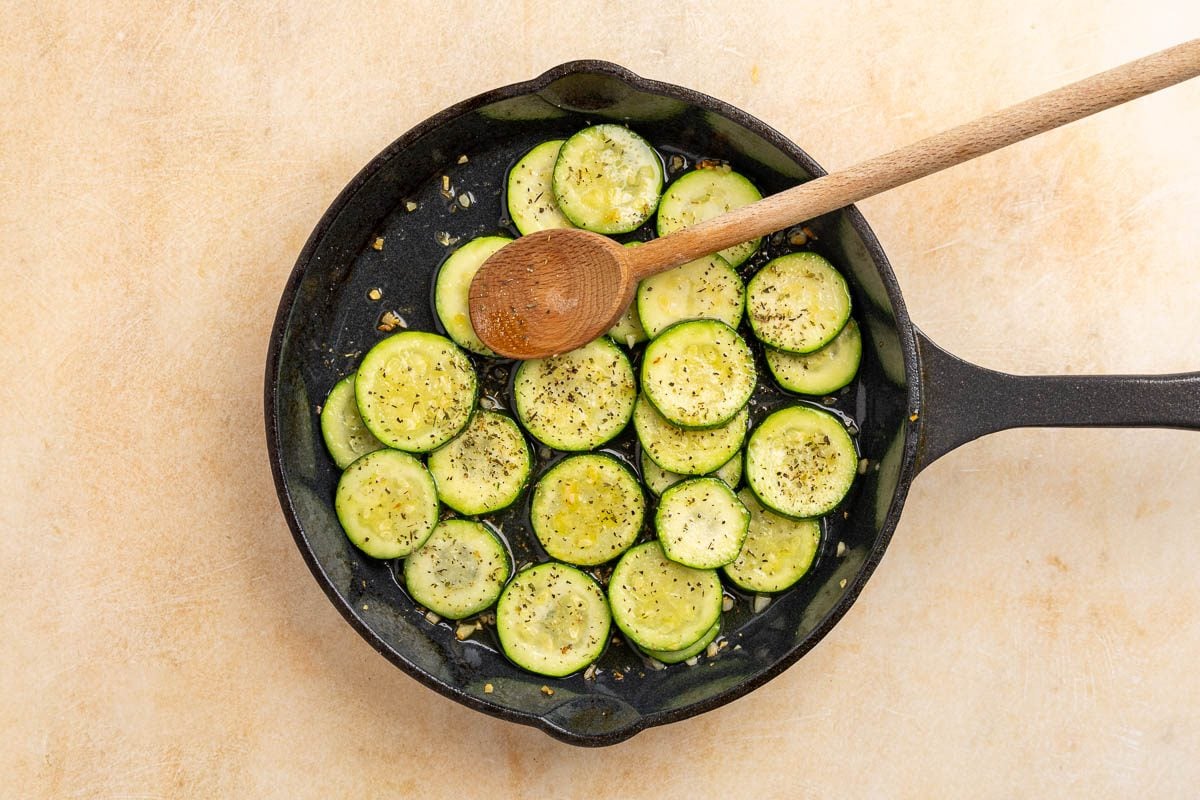 Taste of Home sauteed zucchini recipe photo of zucchini cooked in a pan with oil.