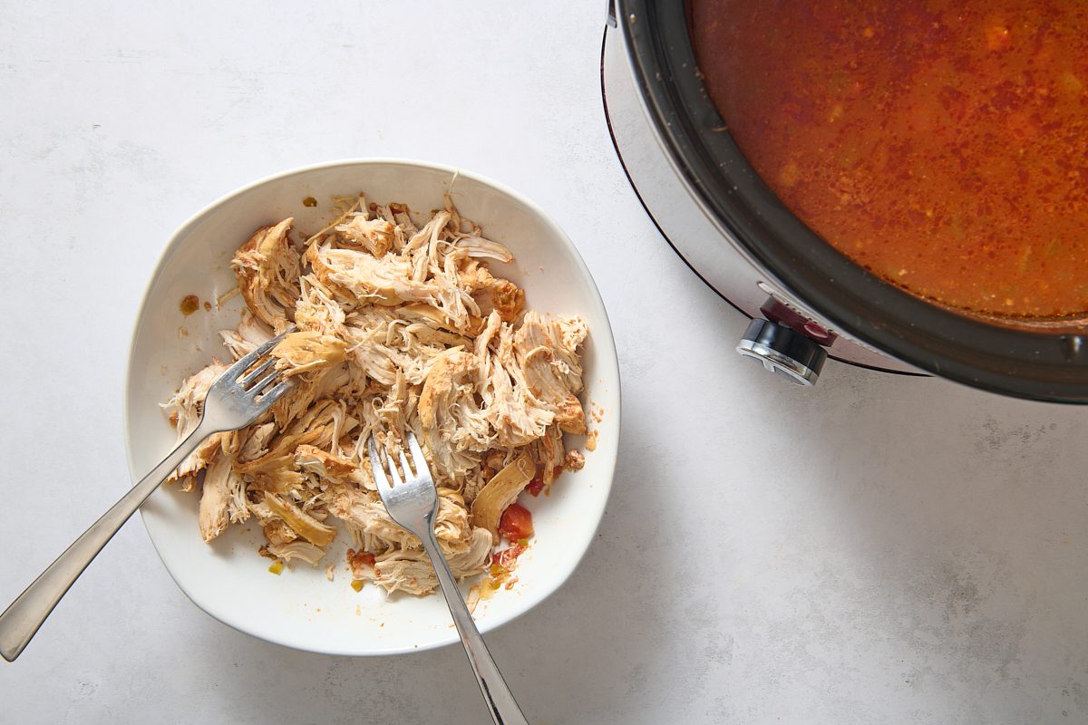 Shredding the chicken with two forks