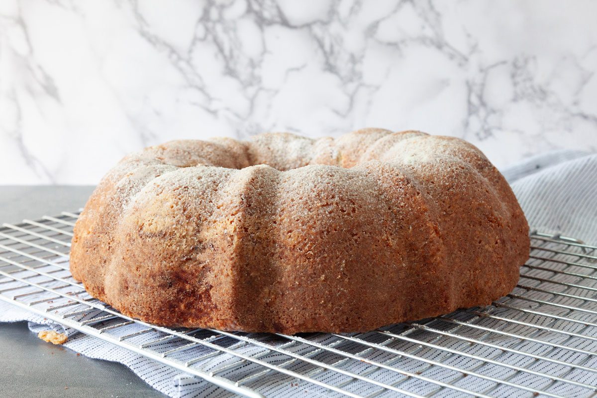 Step 4 of Taste of Home Sour Cream Coffee Cake Bundt is to let the cake sit in the pan for 10 minutes before inverting it to a cooling rack and sprinkling with powdered sugar