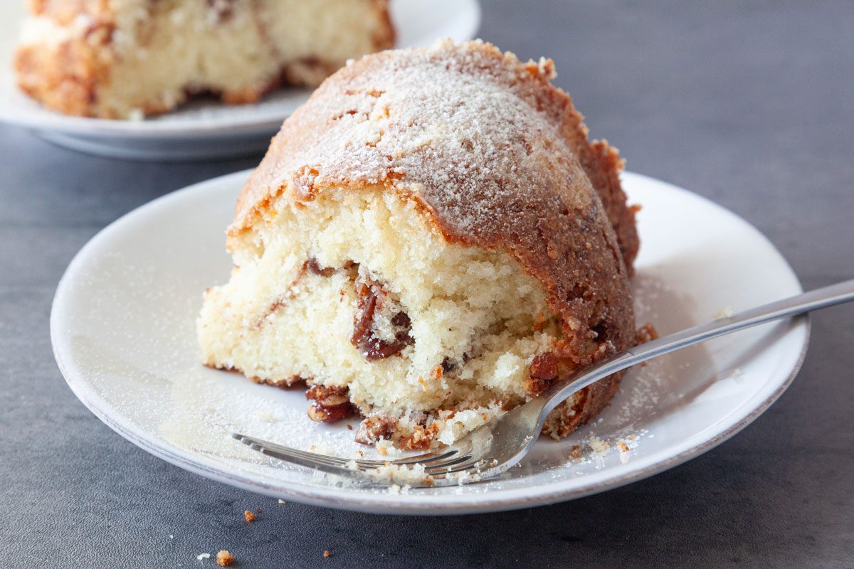 Single servings of Taste of Home Sour Cream Coffee Cake Bundt on small white plates, black surface