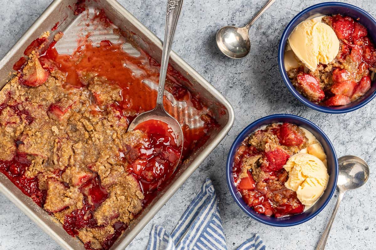 Taste of Home Strawberry Crumble recipe photo of the finished recipe served with scoops of vanilla ice cream.