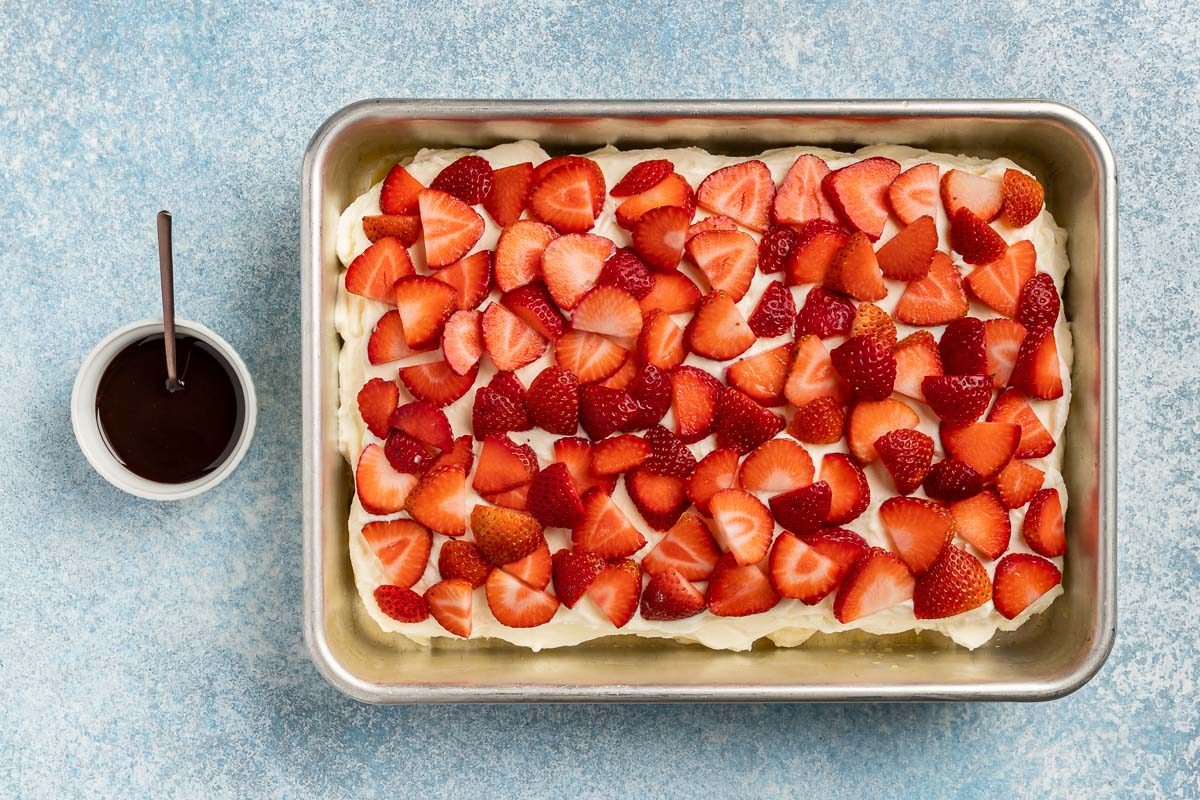 Taste of Home Strawberry Tiramisu recipe photo of the completed tiramisu with chocolate sauce on the side.