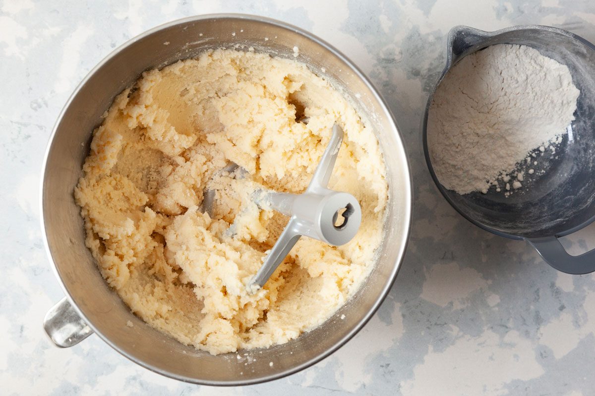 Step 1 of Taste of Home Swedish Cookies is to cream the butter and sugar together until light and fluffy, which should take about five to seven minutes. Add the maple syrup to the mixture. In a separate bowl, combine the flour and baking soda. Add the dry mixture to the creamed mixture gradually. Mix everything well