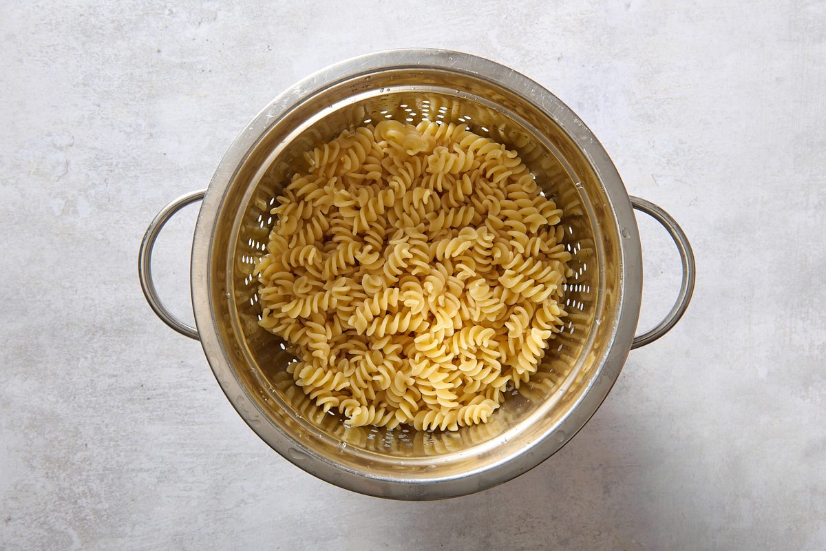 Cooked spiral pasta draining in a colander