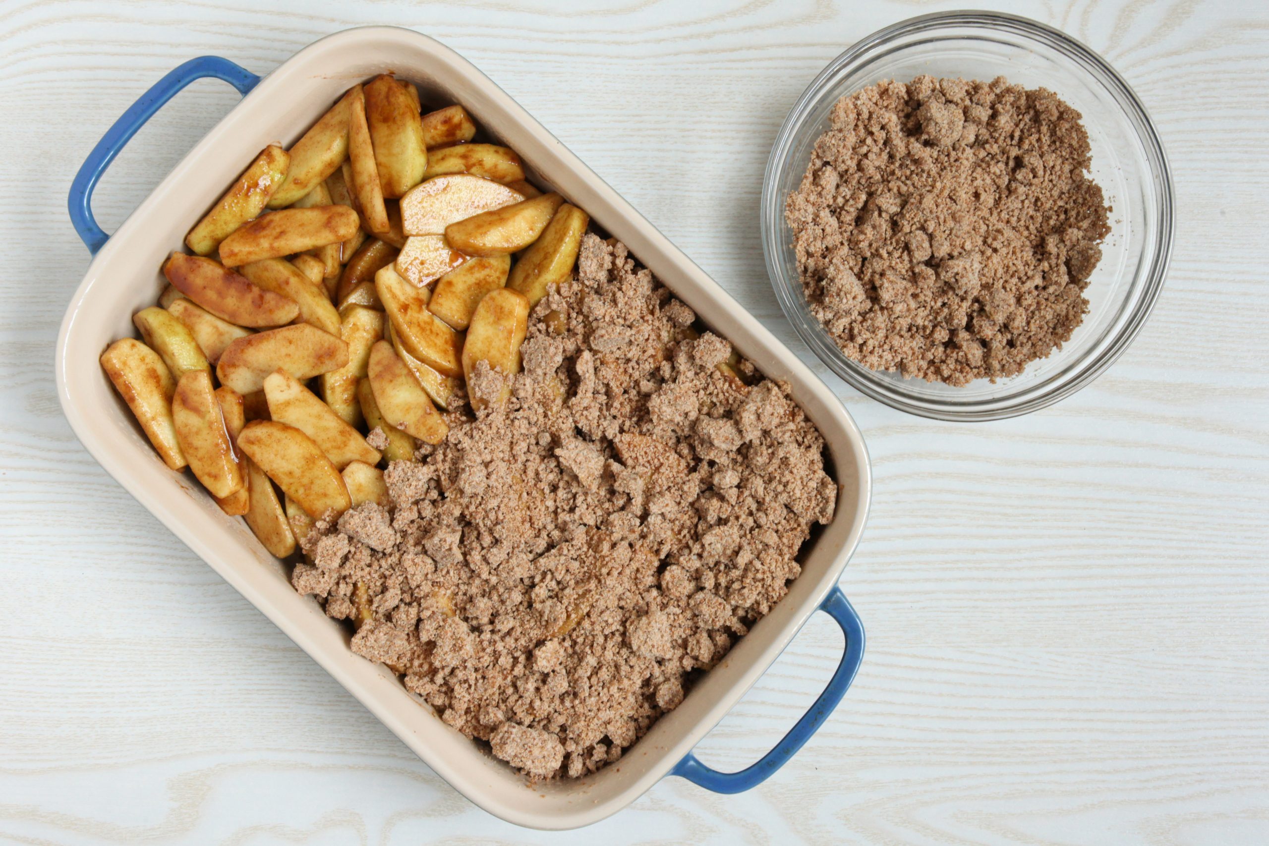 Assembling vegan apple crumble before baking it