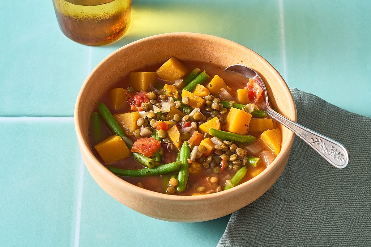 Vegetable Lentil Soup in a bowl with a spoon