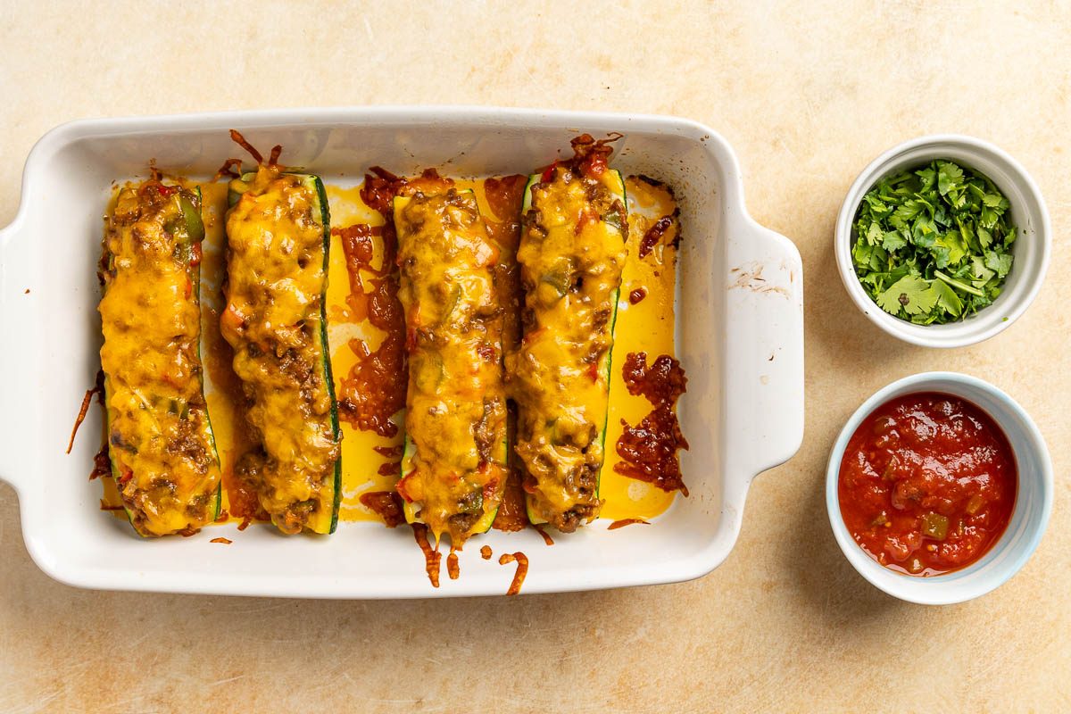 Taste of Home Zucchini Taco Boats recipe photo of the zucchini boats topped with the meat filling and baked with extra cheese on top.