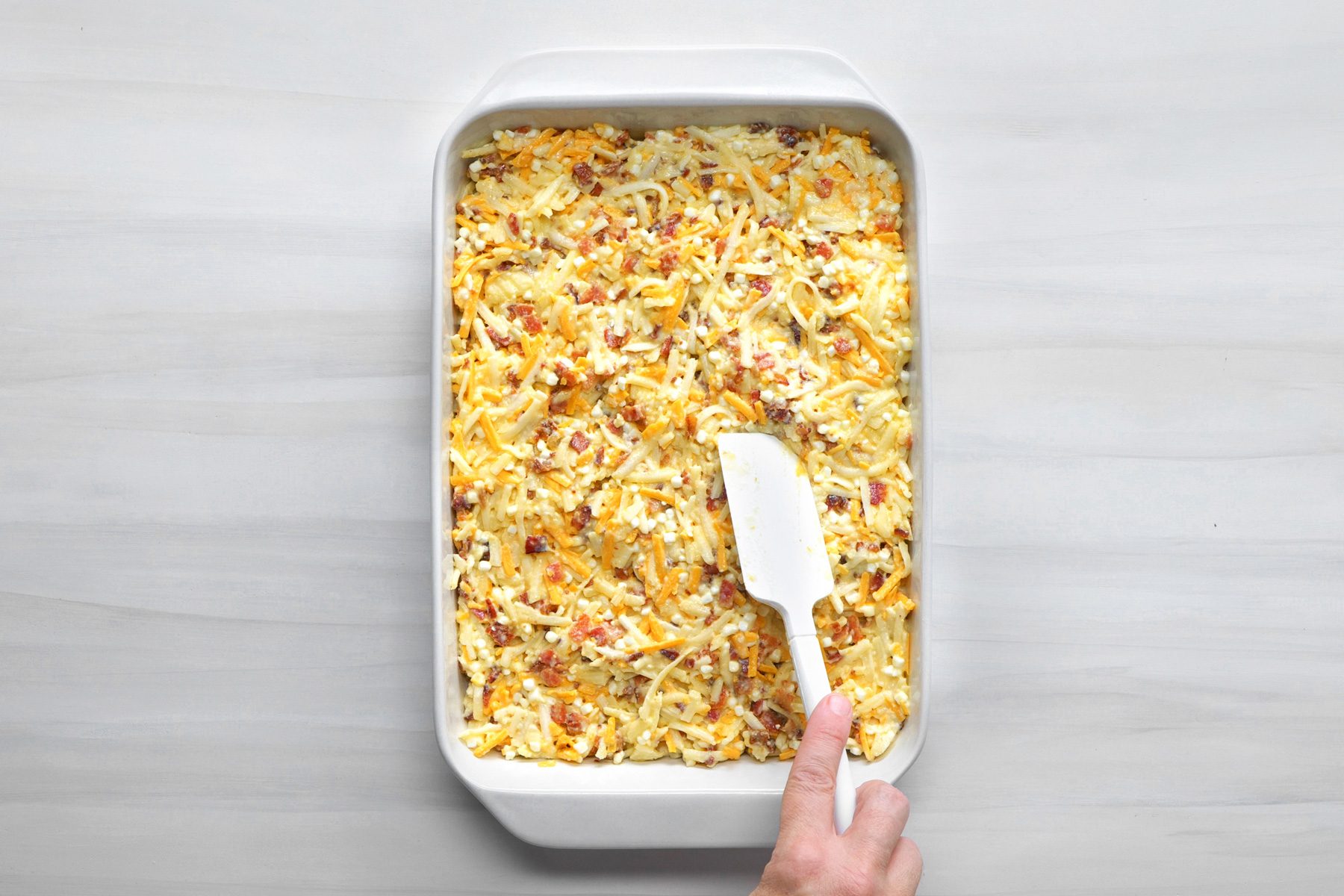 overhead shot; white background;Transferred the mixture to a greased baking dish