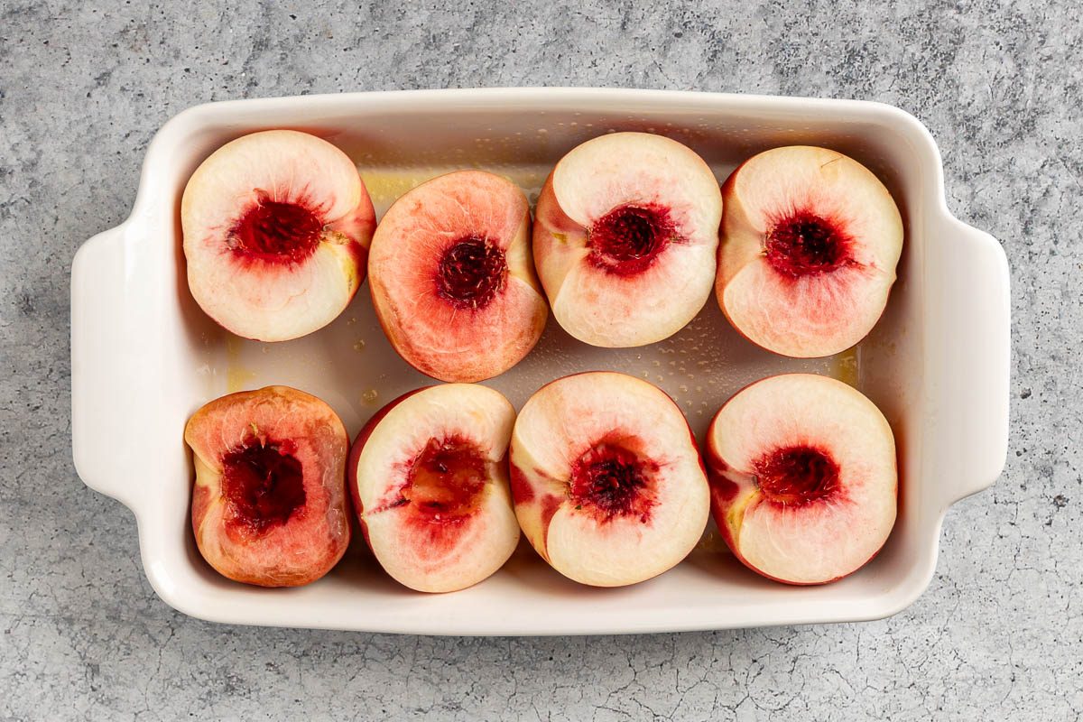 Taset of Home Baked Peaches photo of the peach halves in a baking dish.