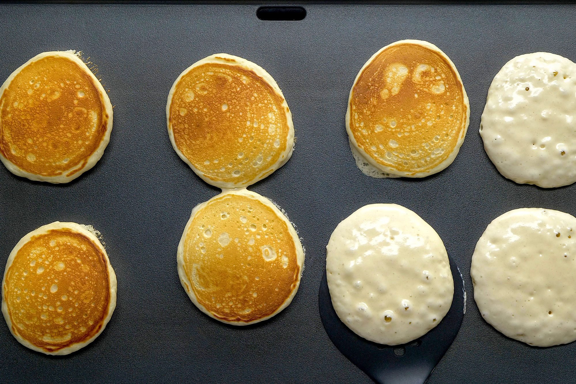 Pour batter by 1/4 cupfuls onto a lightly greased hot griddle;