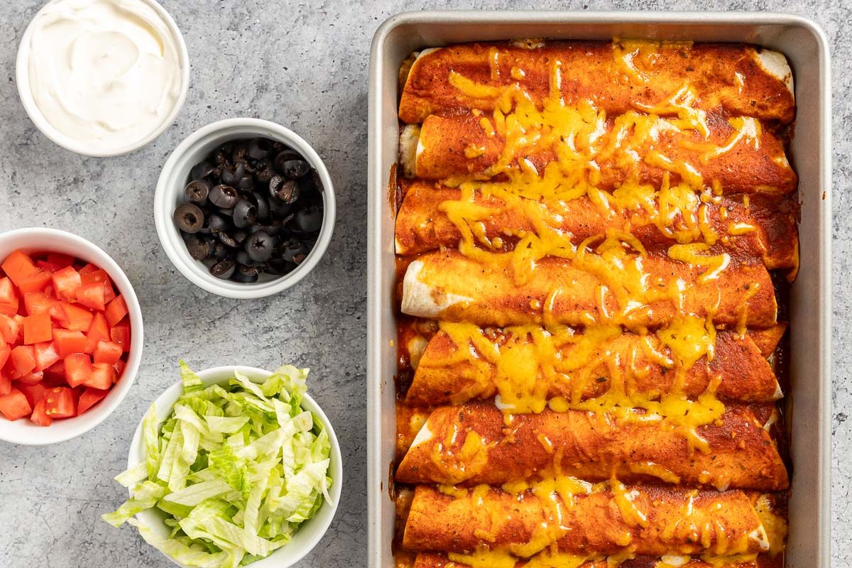 Taste of Home Cheese Enchiladas recipe photo of the baked enchiladas with optional sides.