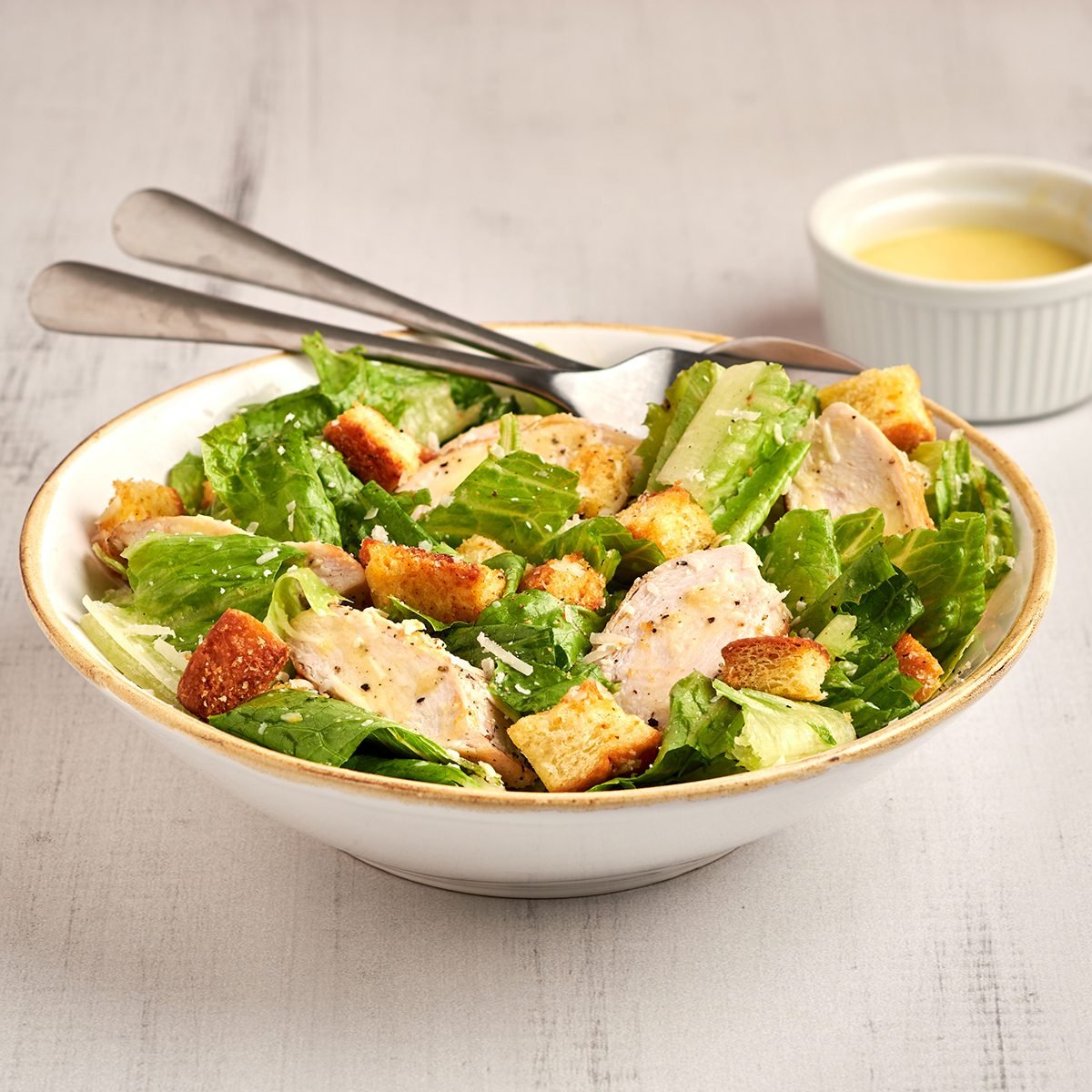 Ready in just 10 minutes, this classic chicken caesar salad by Taste of Home features tender chicken breast, crisp romaine and a zesty homemade dressing.