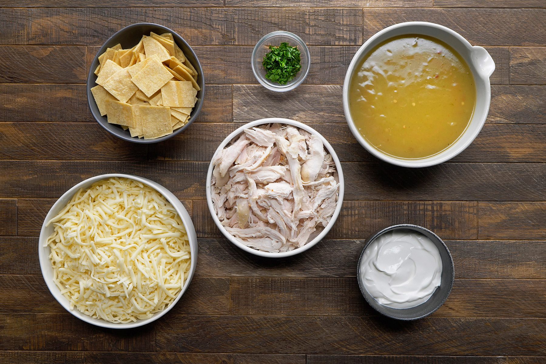 overhead shot of Chicken Enchilada Bake ingredients placed over wooden background