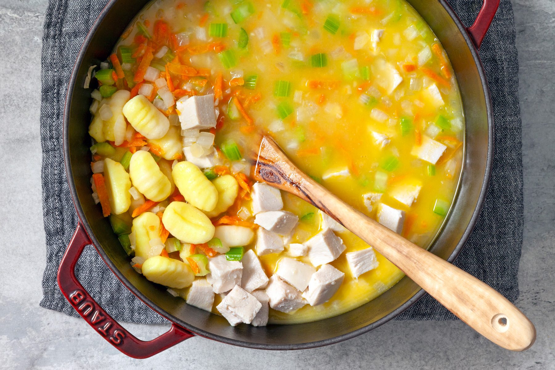 Adding gnocchi and chicken to the mixture 